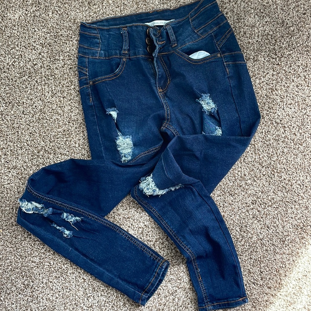 Distress denim.  Size 3.   Three button closure with zipper.